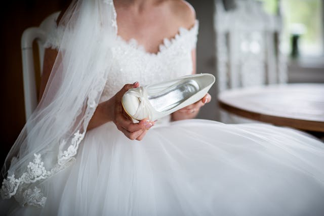 bride holding shoe