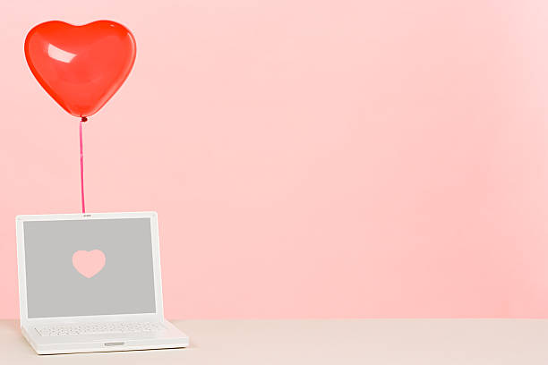 Laptop with a heart balloon
